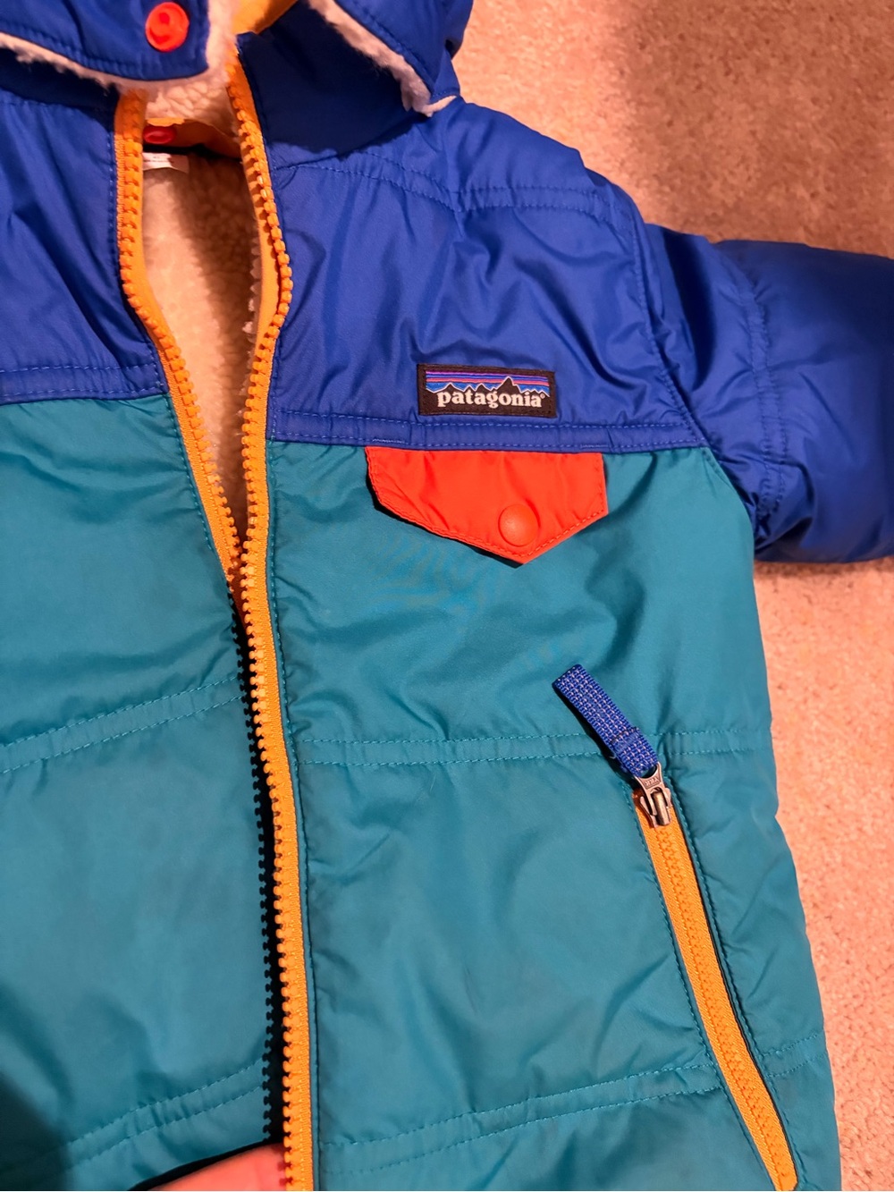 Patagonia Blue Teal Jacket with Orange Accents